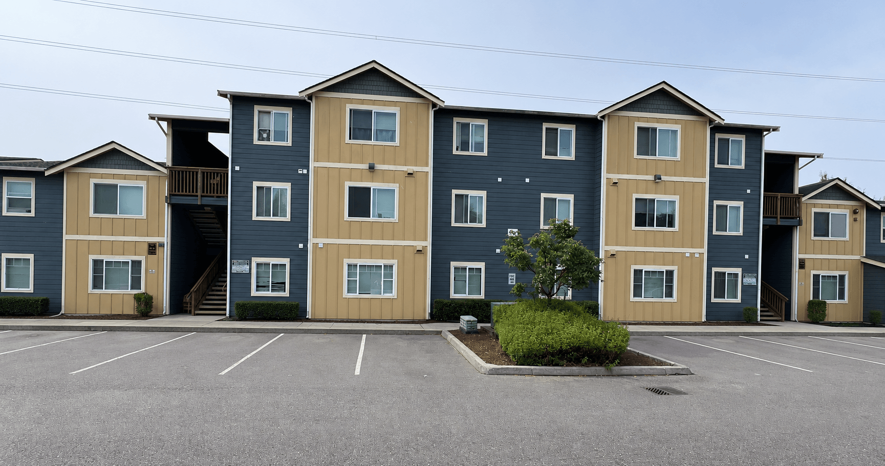 A parking lot in front of a row of townhouses.